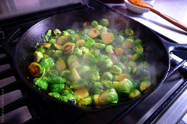 Brussles sprouts cooking in a cast iron pan