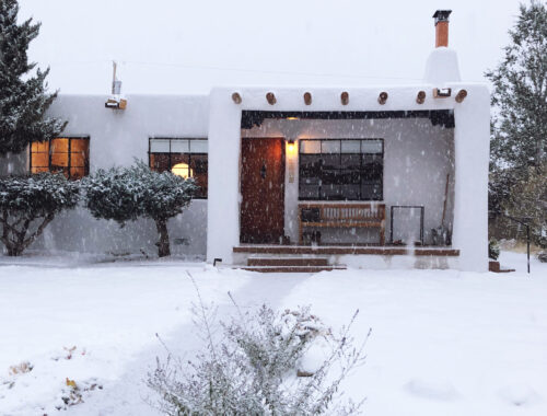 Santa Fe pueblo-style house in the snow - doorsixteen.com