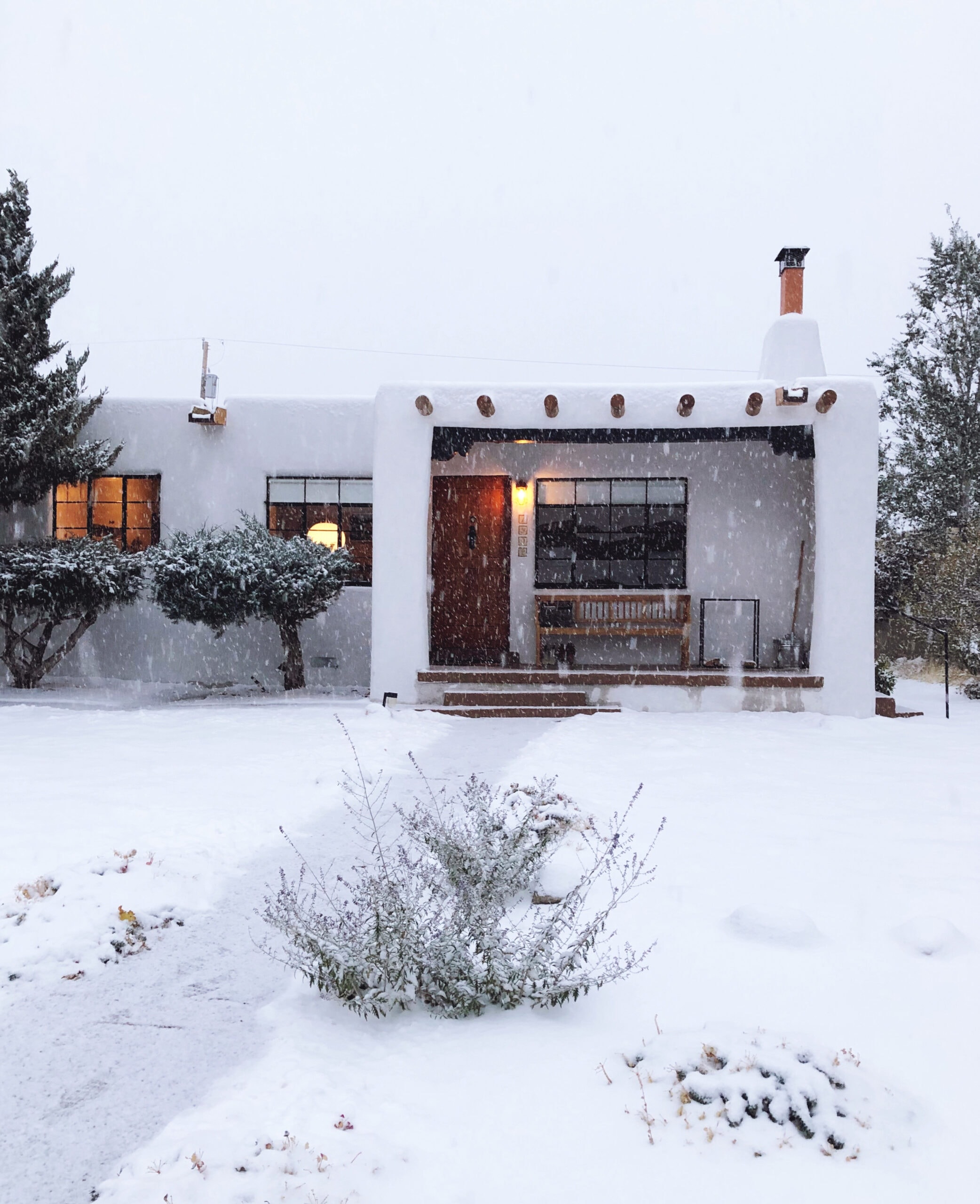 Santa Fe pueblo-style house in the snow - doorsixteen.com