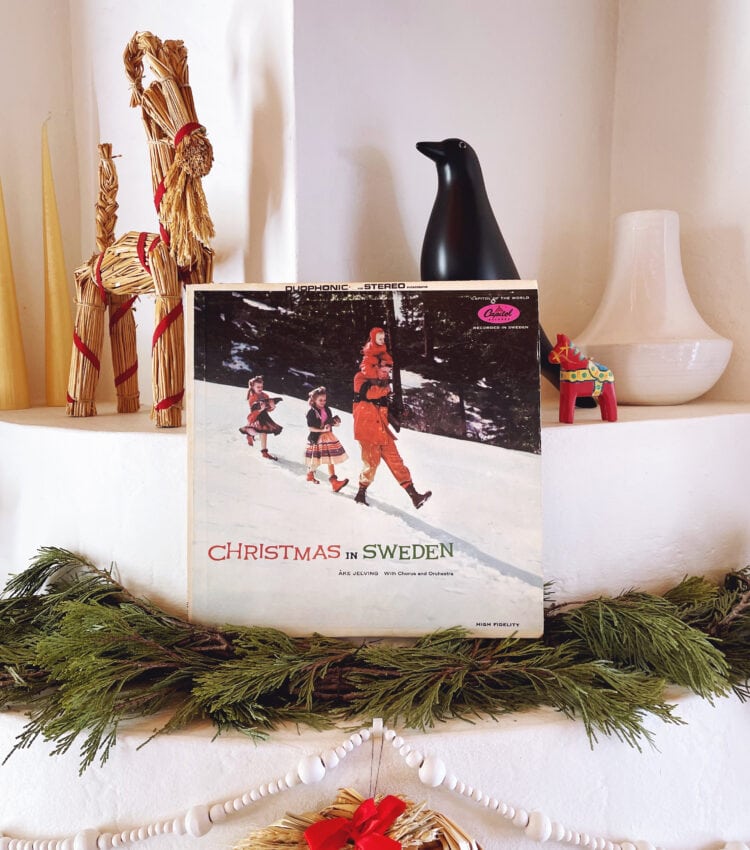 Photograph of Åke Jelving's 'Christmas in Sweden' record album sitting on a traditional New Mexico fireplace surrounded by Swedish Christmas decorations